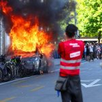 G7 Protest Turns Violent, Demonstrators Torch Tesla, Smash UN Office